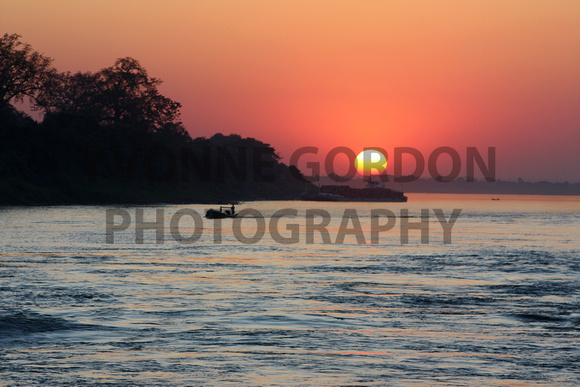 110 Burma - The sun setting on the Irrawaddy River, Burma (Myanmar), photo by Yvonne Gordon